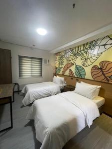 Postel nebo postele na pokoji v ubytování Maharlika City Inn