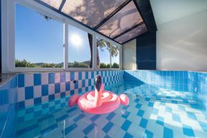 a swimming pool with a red ring in the water at Yesan Hiyella Kids Pension in Hongseong