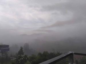 a foggy view of a mountain in the sky at สิรีรินทร์ ภูหมอก in Khao Kho