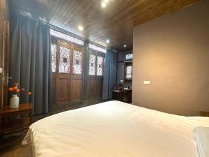 Postel nebo postele na pokoji v ubytování Wuyuan Koshin Homestay