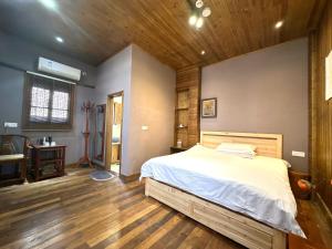 Postel nebo postele na pokoji v ubytování Wuyuan Koshin Homestay