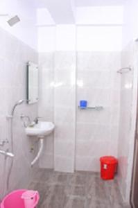 a bathroom with a shower and a sink and a toilet at SEA SUN PARADISE, OPP. KALAPANI MUSEUM, GARACHARMA in Port Blair +14 photos