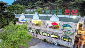 an overhead view of a house with umbrellas on it at Kkotjipureunsol Pension in Taean