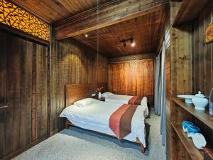 Postel nebo postele na pokoji v ubytování Wuyuan Koshin Homestay