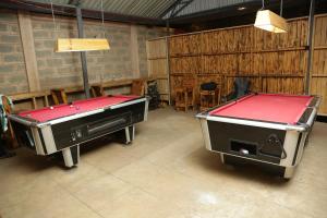 two ping pong tables in a room with a ping pongetitive at Diamond Delight Boutique Hotels in Moshi