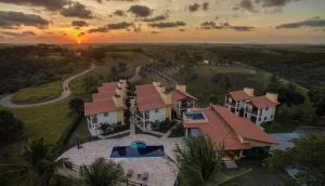 an aerial view of a house with a sunset at Pousada Villa das Palmeiras in Paripueira