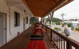 a row of benches on the porch of a house at Anmyeondo Taean Romance Pension in Taean +11 photos