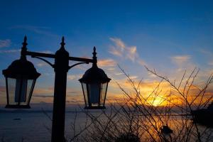 two street lights with the sunset in the background at Byeonsanbando Badajeonmangdae Pension in Buan