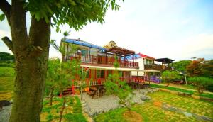a large house with red and blue at Namusori pension in Goesan