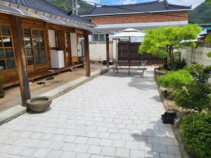 a patio in front of a house with a table at Jeonju Hanok-an hanok an Pension in Jeonju