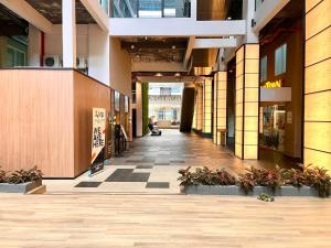 an empty hallway of a building with plants at Hillton Suites in Ayer Keroh
