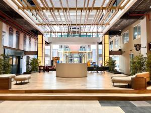 a lobby with a reception desk in a building at Hillton Suites in Ayer Keroh