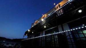 a building with lights on top of it at night at Bangpo Sea Pension in Taean