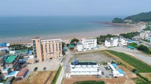 an aerial view of a city with a beach and buildings at Bangpo Sea Pension in Taean +12 photos