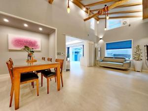 a dining room with a table and chairs and a couch at Byeoldul Private Pension in Jeonju