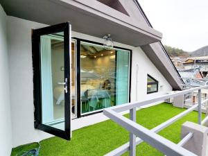 a balcony with a glass door on a house at Byeoldul Private Pension in Jeonju +12 photos