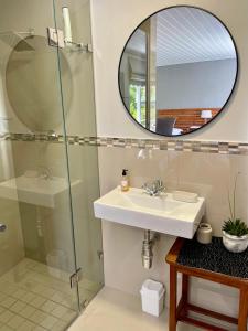 a bathroom with a sink and a mirror at Stellenbosch Serenity Suite in Stellenbosch