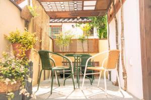 a patio with chairs and tables on a balcony at Happiness on Jacuzzi Private Pension in Jeonju