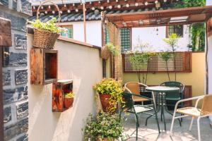 a patio with a table and chairs and plants at Happiness on Jacuzzi Private Pension in Jeonju +4 photos