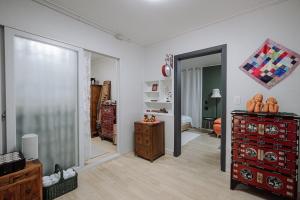 a living room with a dresser and a mirror at Jeonju Hanok Village Artist’s House Sigan Moonui in Jeonju