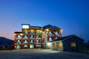 a large building with lights on in front of it at Gyeokpo Seohae Oceanville Pension in Chungmak-tong