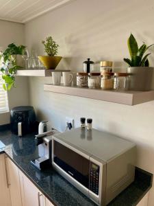 a microwave on a counter in a kitchen at Stellenbosch Serenity Suite in Stellenbosch