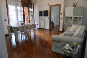 a living room with a couch and a table at Luciana Apt - 3 min train to FCO Airport & Fiera in Fiumicino