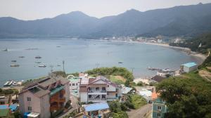 a view of a beach with boats in the water at Geoje Ocean Love Pension in Geoje 
