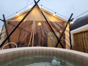 a tent with a hot tub in front of it at boeun ilsanghwa gramping in Ch'ŏngch'ŏl-li +34 photos