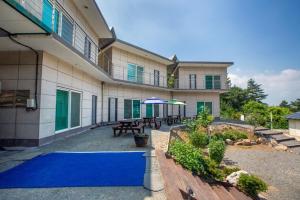 a large building with a blue carpet in front of it at Taean Scenic Pension in Taean