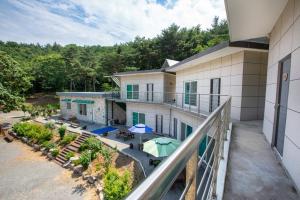 an aerial view of a building with a patio with umbrellas at Taean Scenic Pension in Taean +21 photos