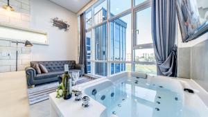 a large bath tub in a room with a large window at Gangneung Hygge Nobile Pension in Gangneung