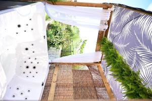 a view from the balcony of a house with white curtains at Goseung Luceluna Pension in Yongch'ol-li