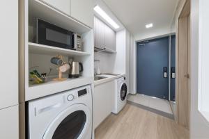a laundry room with a washer and dryer at Sokcho Rianvichae Central in Sokcho