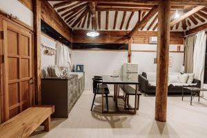 a kitchen and dining room with a table in a room at Luwa Private Pension in Jeonju