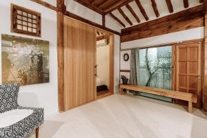 a living room with a wooden door and a window at Luwa Private Pension in Jeonju +34 photos