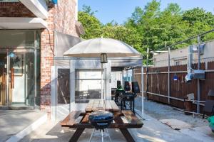 a patio with a table and an umbrella at Gangneung Marine Park Pension in Gangneung
