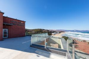 a view of the beach from the balcony of a hotel near the ocean at Donghae Staypear471 in Donghae