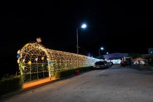 a building decorated with christmas lights at night at Jeongeup Geumgang Duseungsan Glamping in Jeongeup