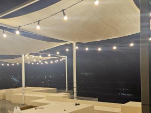 a white tent with lights and a view of the city at Goseong Stay Naru in Goseong