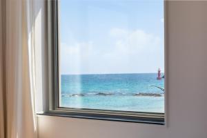 a window with a view of the ocean at Donghae Adal Ocean Pension in Mukho-dong