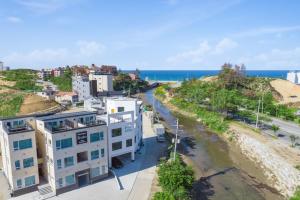 an aerial view of a building next to the beach at Gangneung Dislo in Gangneung
