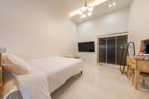 Postel nebo postele na pokoji v ubytování Gangneung 1012 Pension