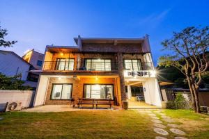 a house with a bench in front of it at Ganghwa Bridge House in Incheon