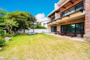 a yard with benches and a building at Ganghwa Bridge House in Incheon