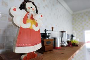 a figurine of a woman on a counter in a kitchen at Geoje olive couple pension in Geoje 