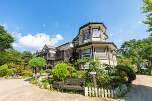 a large house with a fence in front of it at Ganghwa Teo Pension in Incheon