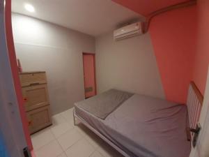 a small bedroom with a bed and a cabinet at New Jasmine in Karangtengah