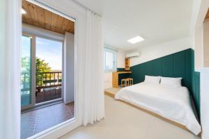 a bedroom with a bed and a large window at Gyeongju Insta Spa Pension Spa, Individual BBQ in Gyeongju +16 photos