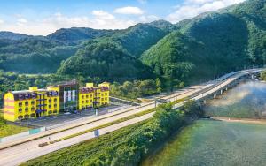 an aerial view of buildings and a bridge over a river at Inje Tourist Hotel in Wŏrhang-ni